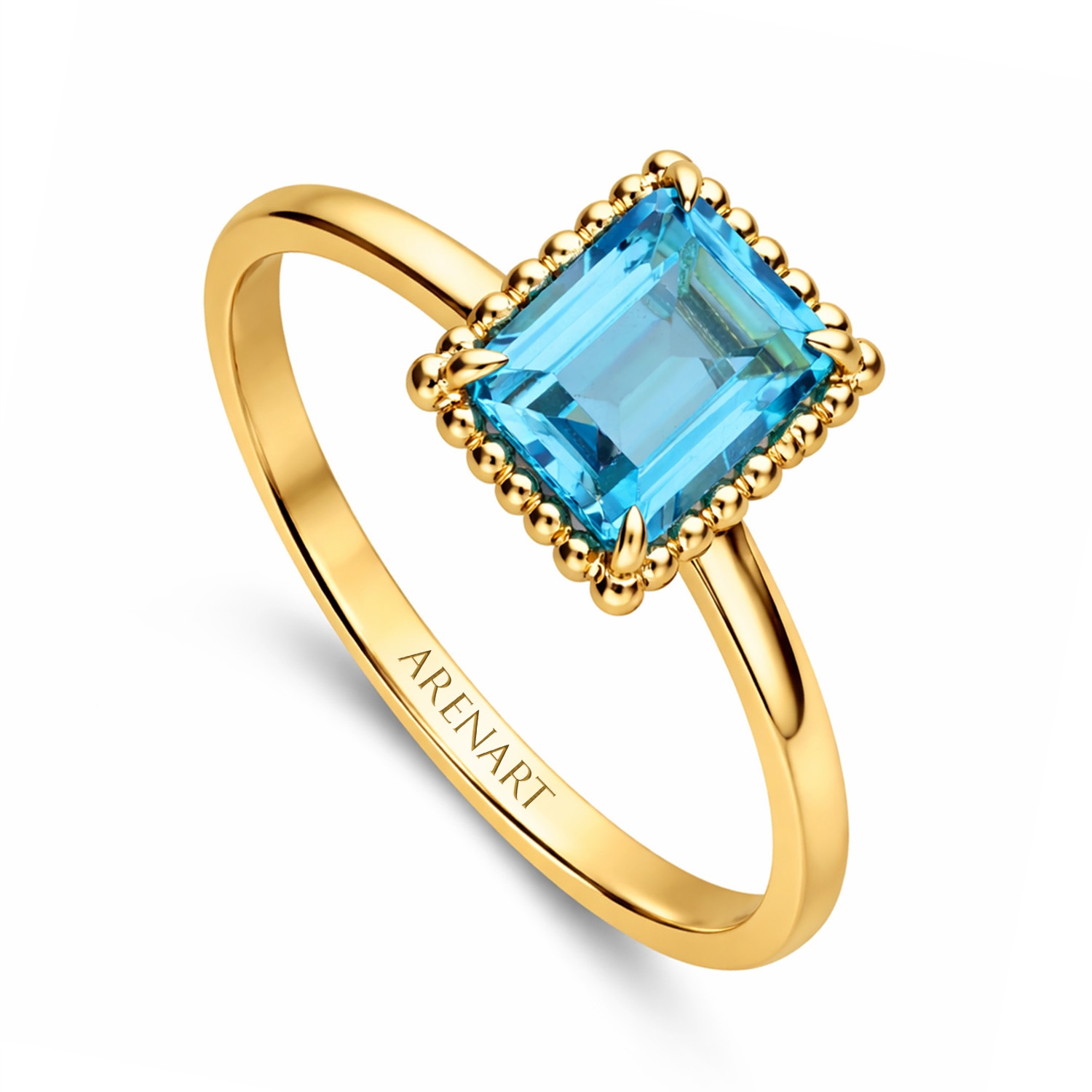 Złoty pierścionek z niebieskim topazem, żółte złoto próby 585